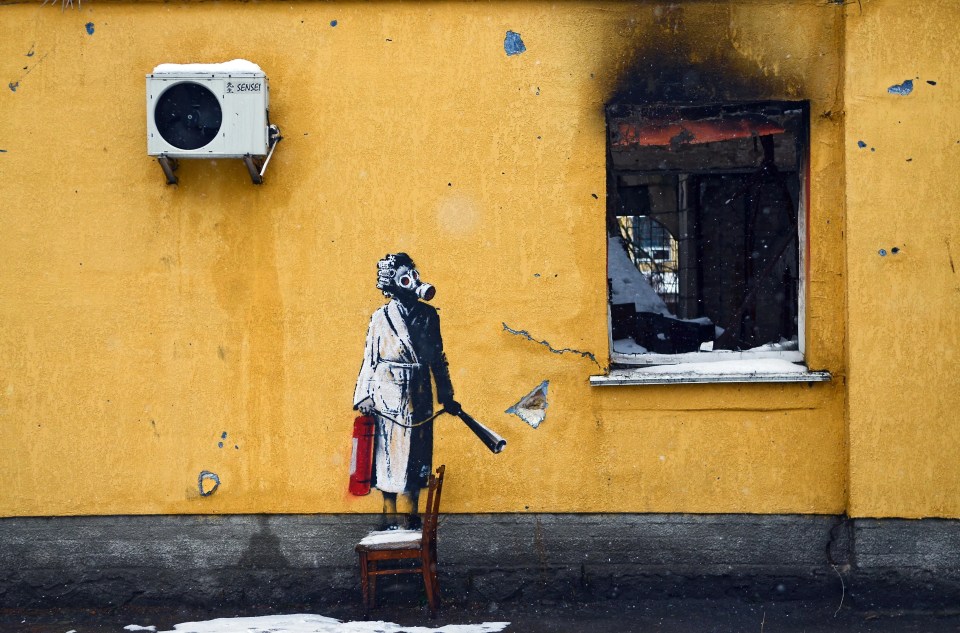 The Banksy artwork shows a woman in a gas mask holding a fire extinguisher