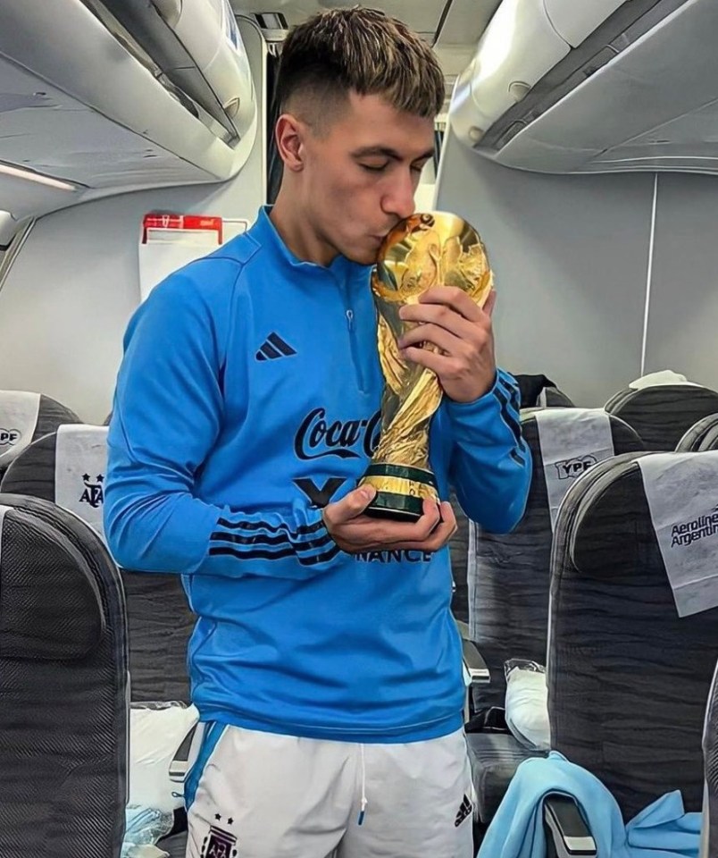 Messi eventually let go of the trophy to allow Manchester United defender Lisandro Martinez grab his picture with it