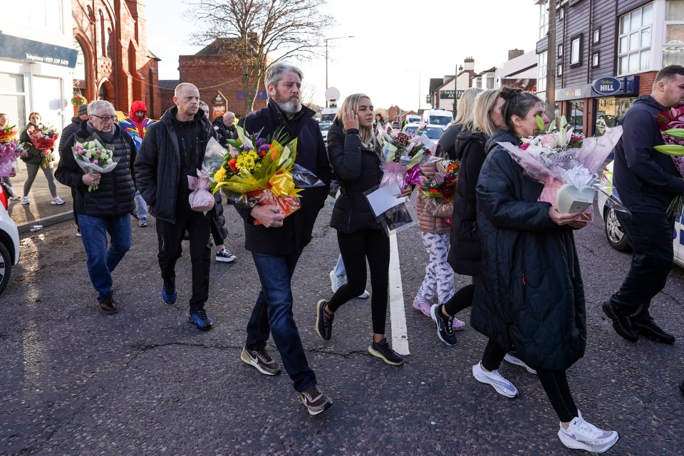 Elle's mum and dad were among those leaving flowers at the scene