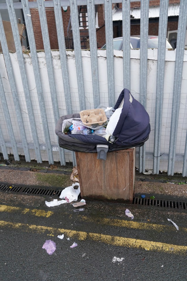 A broken pram is dumped in the street