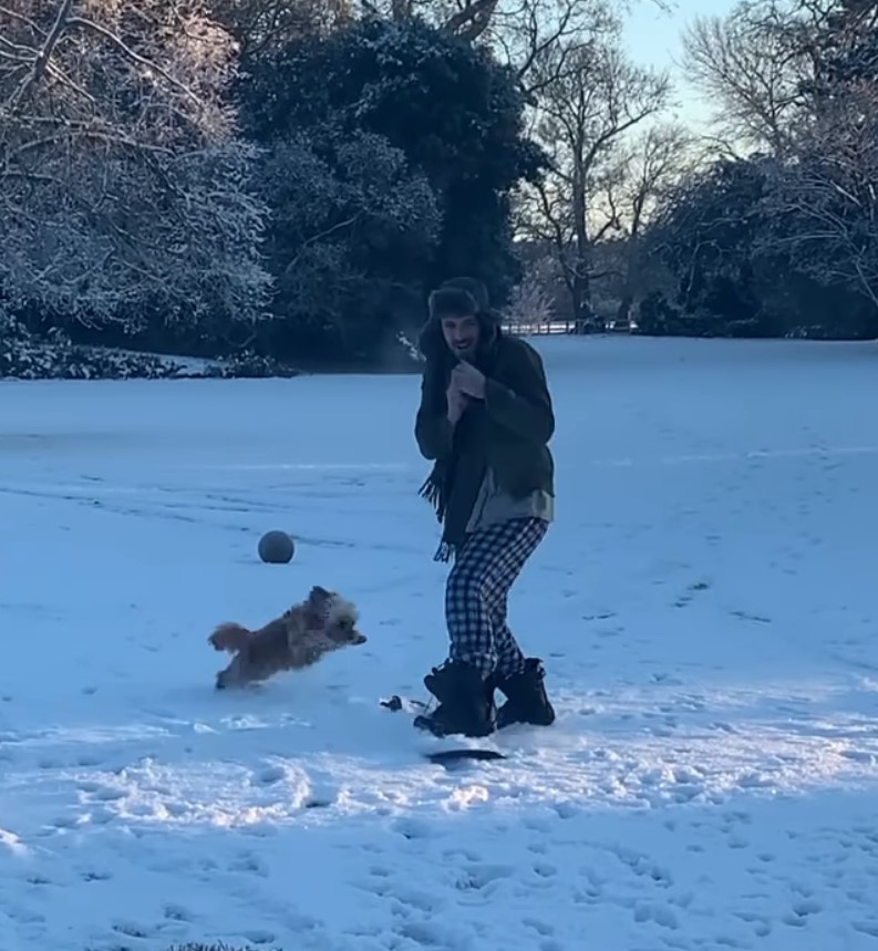 Oliver took out his snowboard as she slid through the garden