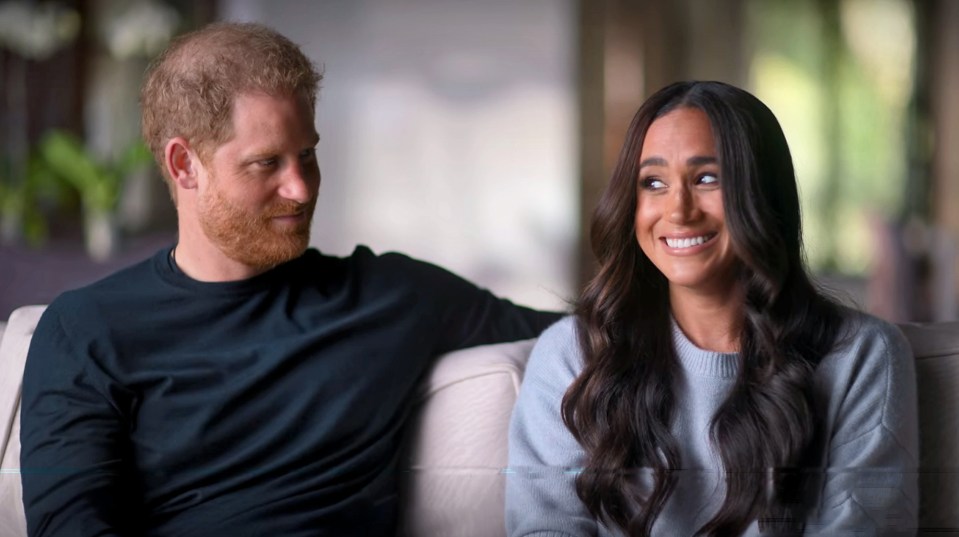 Meghan exaggerates a curtsy to poke fun at the royals during the doc