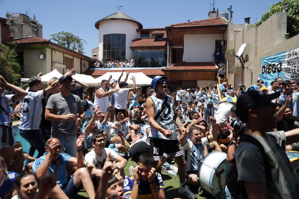 Fans of Argentina celebrate Angel Di Maria’s goal at the former house of Maradona