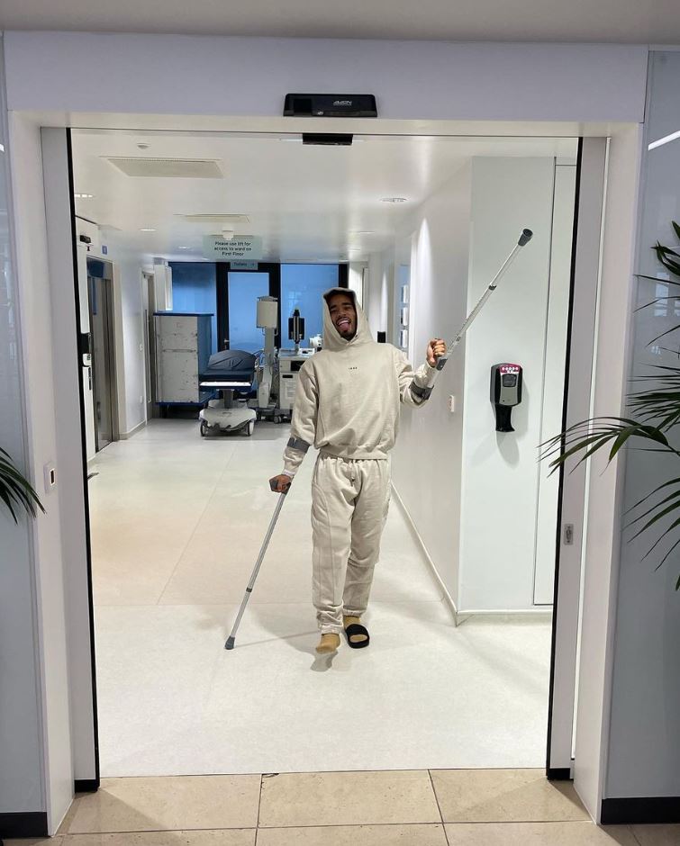 Jesus poses with his crutches as he heads home from hospital