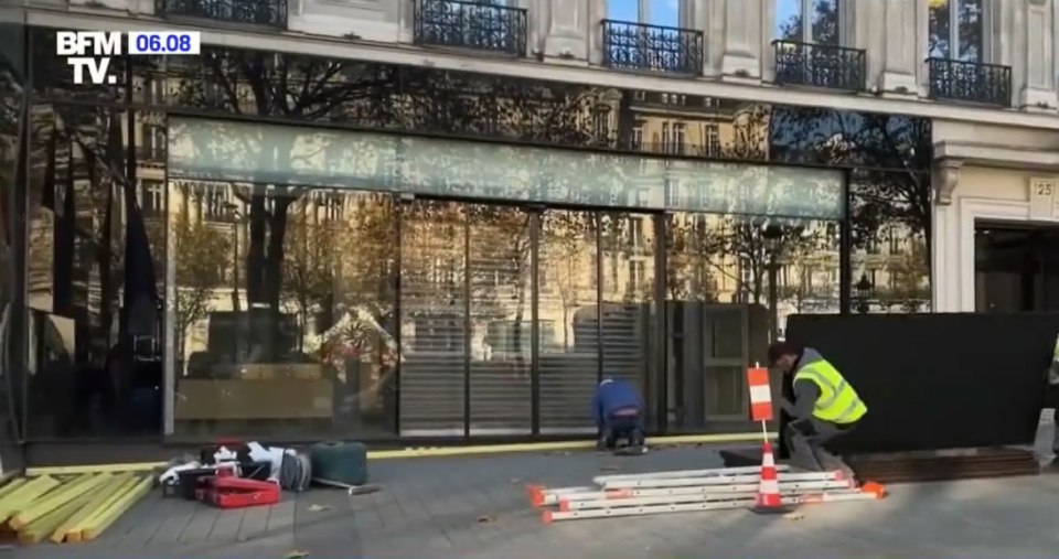 Workers building barricades for shops in Paris due to the damage caused last week