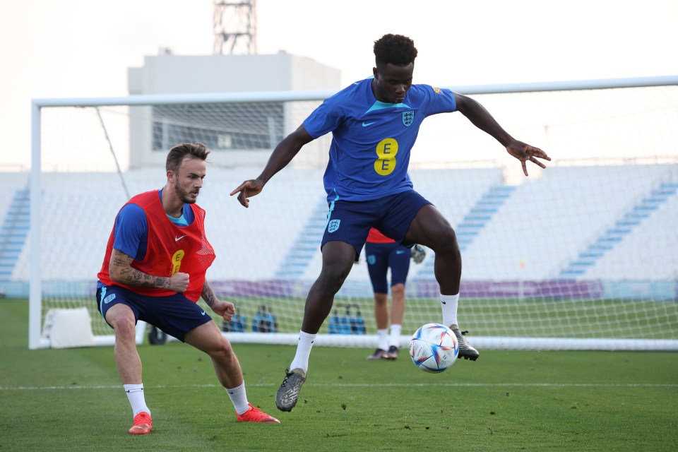 Wideman Bukayo Saka rises to the challenge of shielding the ball from England squad-mate James Maddison in training