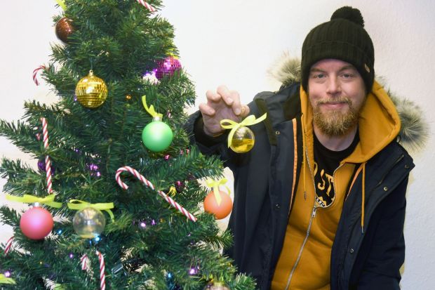 A Christmas tree on display has its baubles filled with bodily fluids