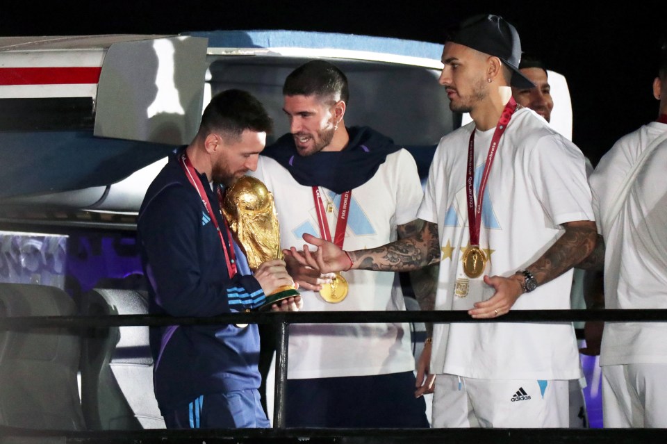 Messi alongside 'bodyguard' pal and fellow winner Rodrigo De Paul