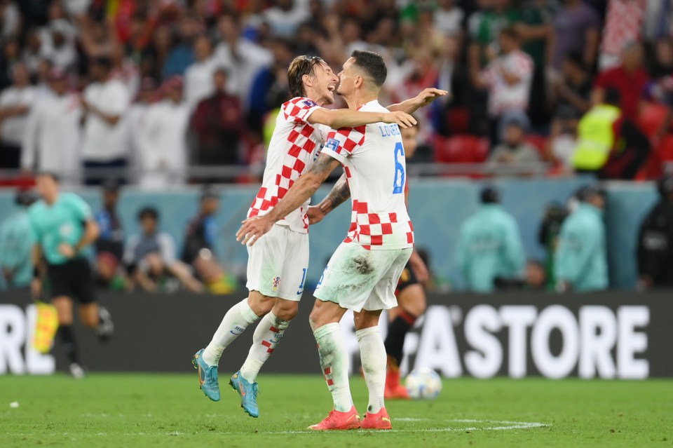 Luka Modric and Dejan Lovren celebrate after Croatia sealed second spot after the goalless draw