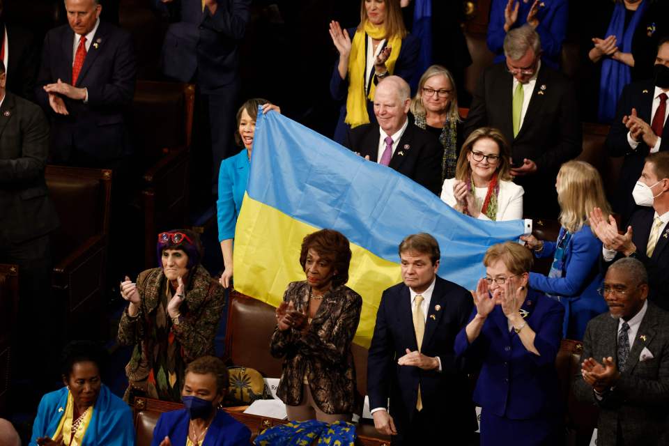 Three members held up a large Ukrainian flag during the ovation