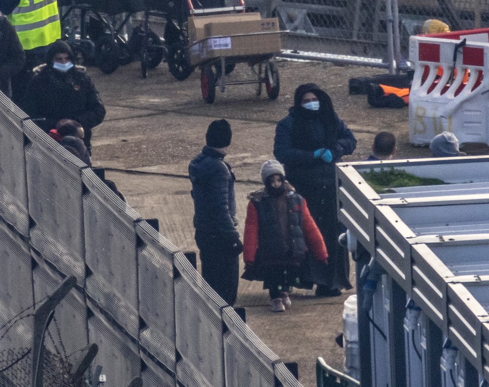 Relived migrants, including youths, which have been rescued from the icy waters arrive in Dover