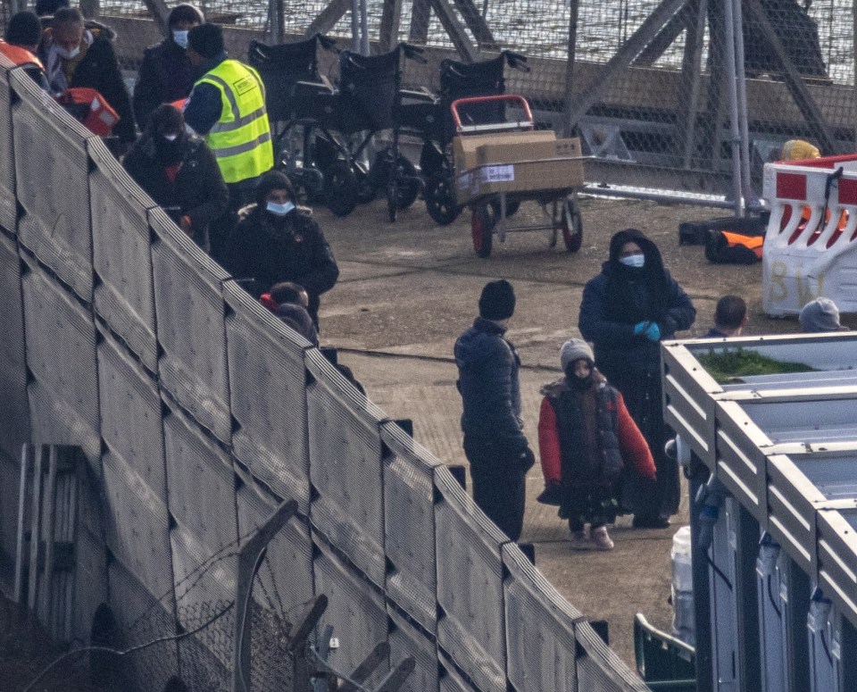 The migrants, including some small children, were taken ashore at the port