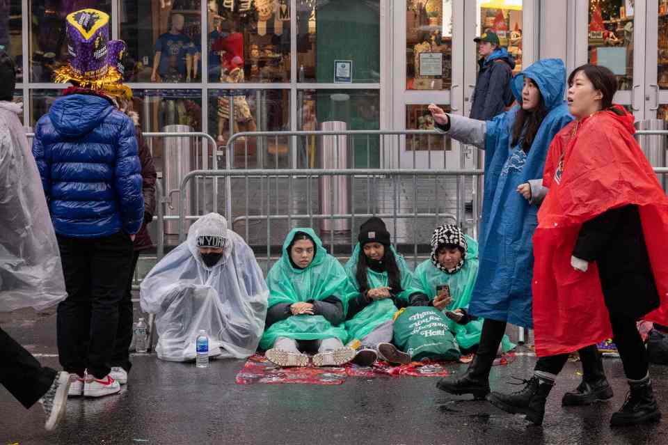 People gather to celebrate the new year and await the ball drop in Times Square