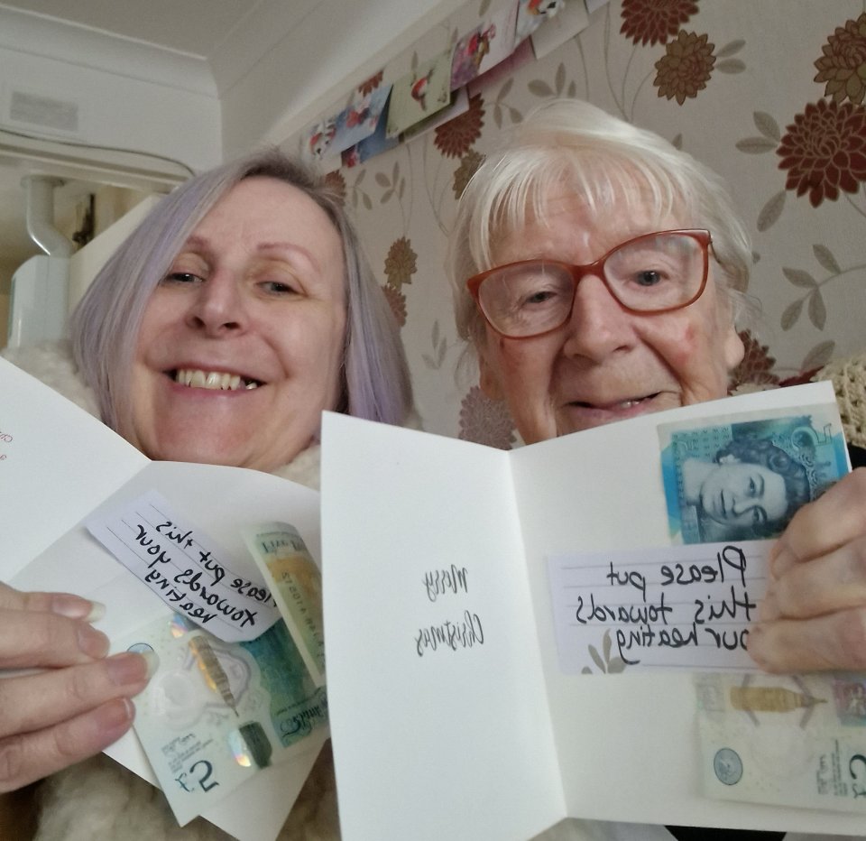 Residents Maxine Parker-Gallagher and Joan Green smile for the camera as they reveal their hero's note