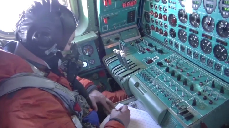 A pilot taking notes during the fly over