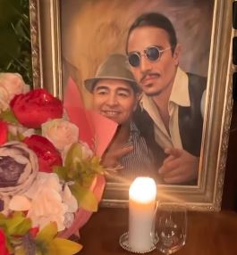 A garish painting of them together sits on the table