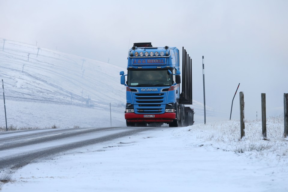 A lorry drives through the snow in Scotland