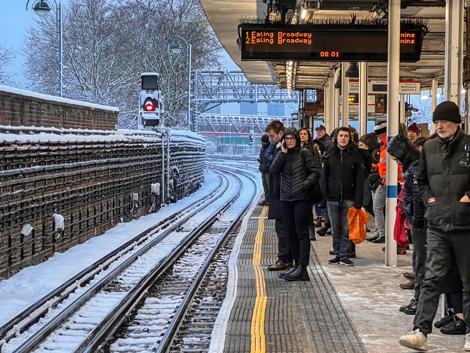 Commuters wait for the tube in the snow at Leytonstone, East London, as snow sparks travel carnage across the country