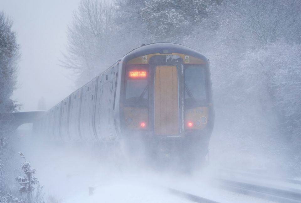 A Southeastern train makes its way through Ashford in Kent as rail services remain disrupted in the icy weather