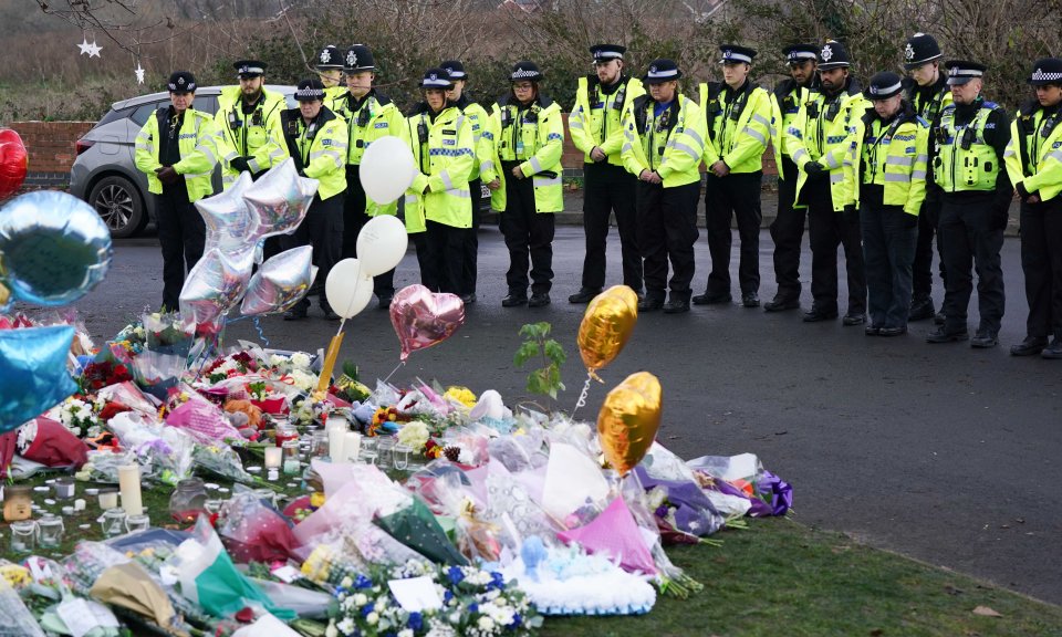 Police officers lay tributes at the scene of the tragedy