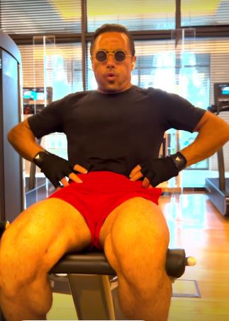 He posed in tiny red shorts at the gym in Dubai