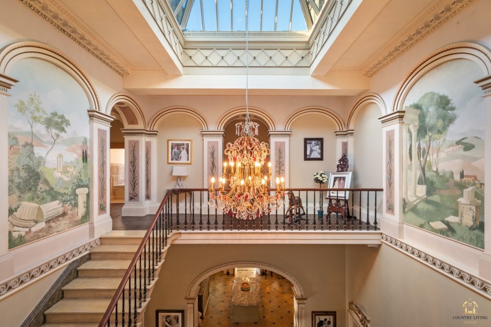 The mansion's sweeping staircase is fit for a queen's cousin