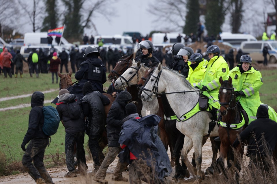 Protesters advancing to Luezterrath are confronted by mounted police