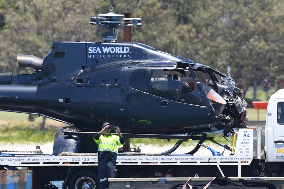 One of the damaged helicopters is towed away from the sandbank