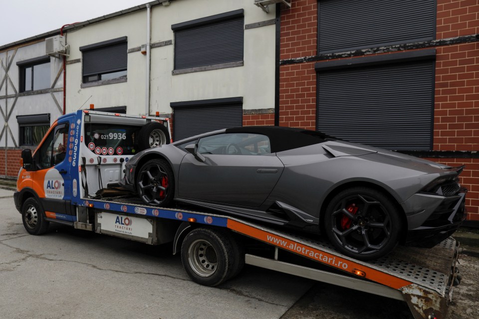 Romanian cops load up a lamborghini on a flatbed truck