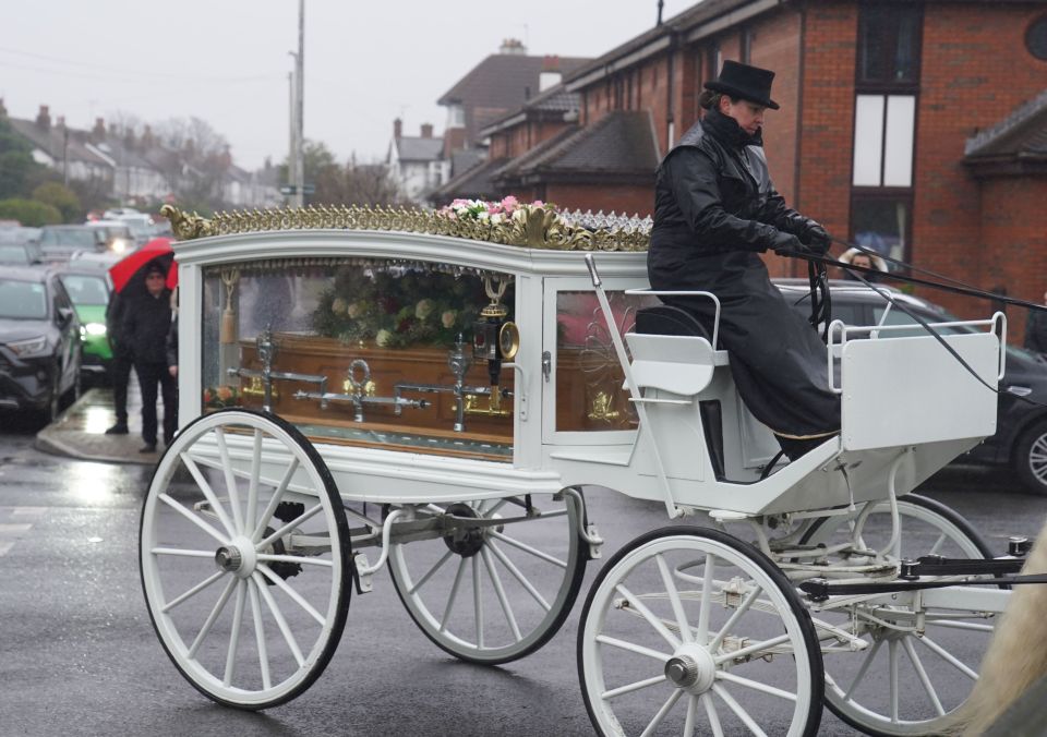 Elle was taken on her final journey to the church in a white carriage