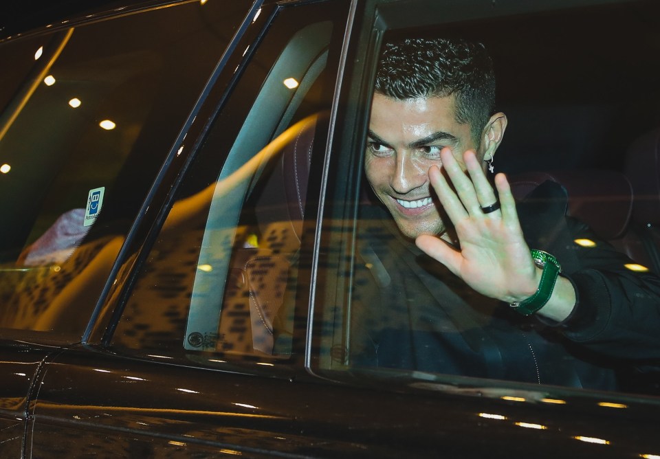 Cristiano Ronaldo waves to fans after touching down