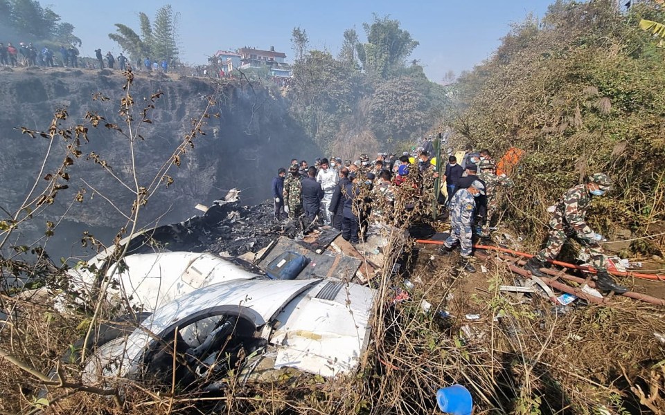 Rescue teams work at the wreckage of the plane