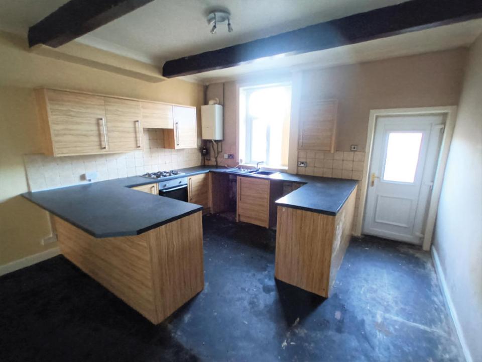 The kitchen is complete with large work surfaces to prepare family meals