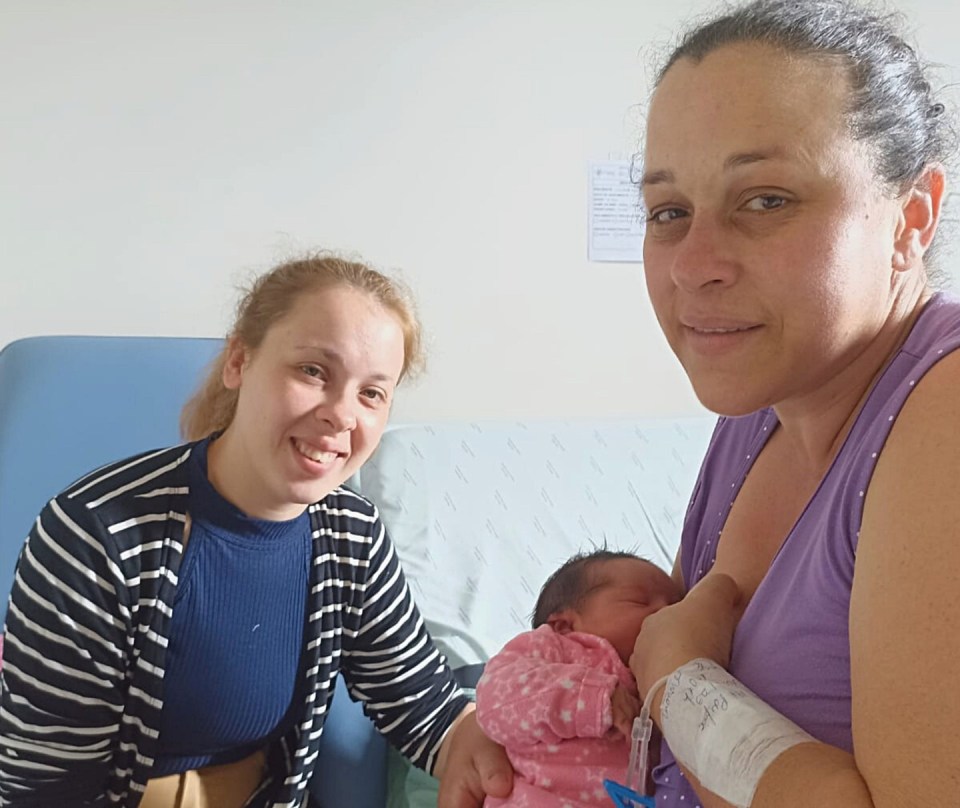 The happy mum with her eldest and youngest daughter after giving birth