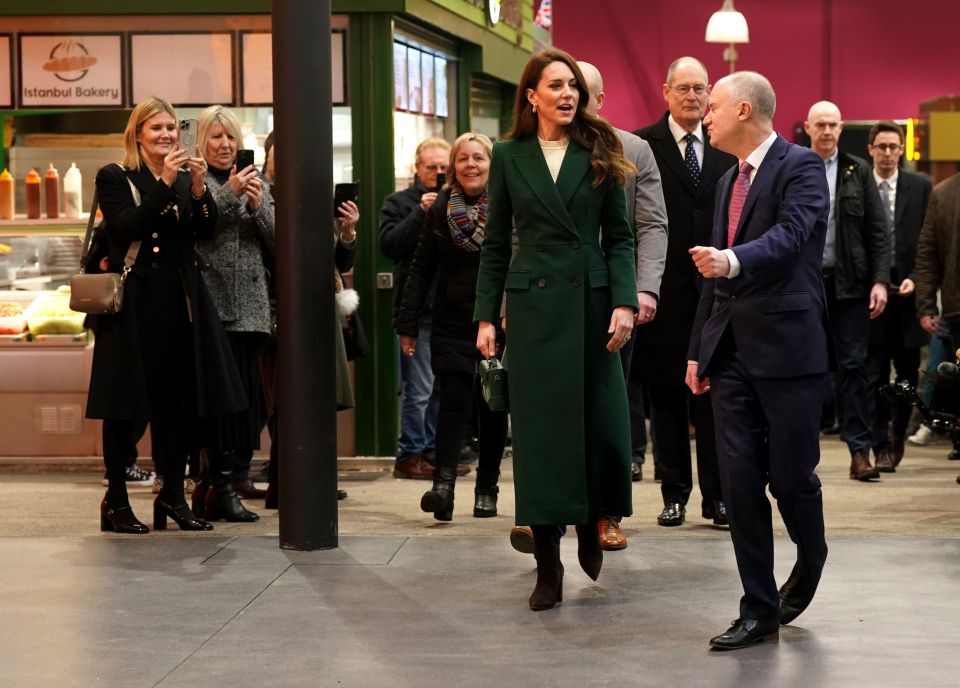 She looked radiant in a longline green coat and suede boots