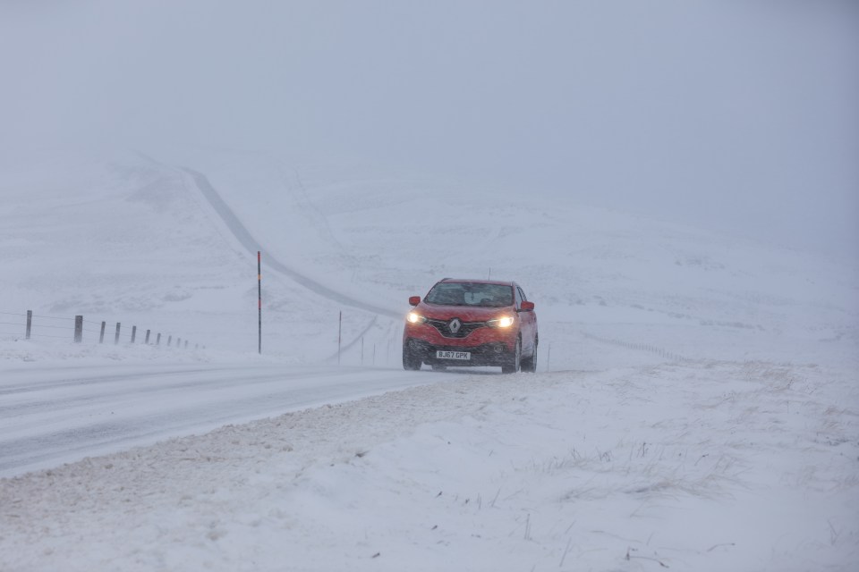 A car makes it way along the A939 after heavy snowfall in the Cairngorms, Scottish Highlands