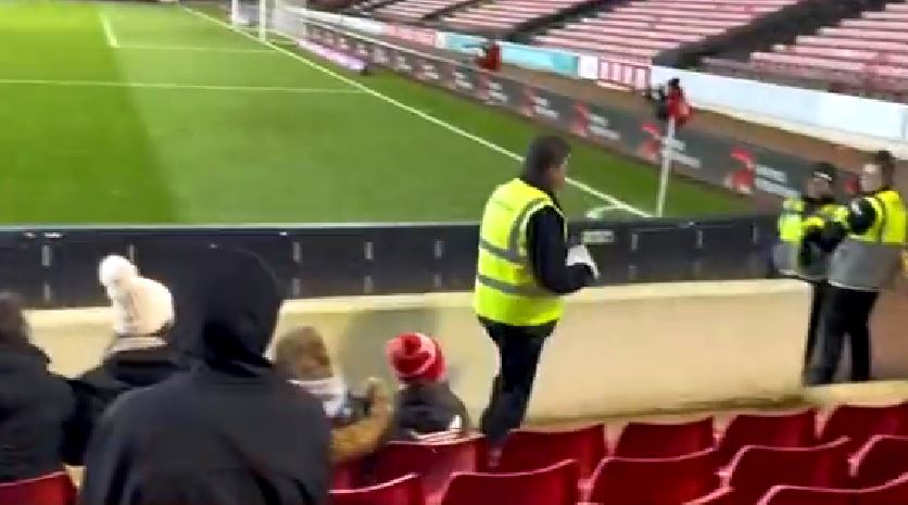 The steward could be seen carrying the girl's number back to the Bolton end