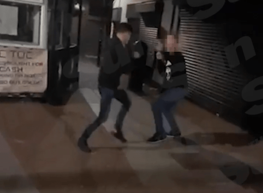 The two men appear to be in a stand-off before they start punching each other