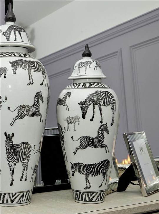 There are zebra vases in the dining room