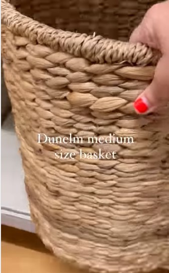 In a new video, she shared how she uses a pizza chopping board and a storage basket to create an expensive-looking side table