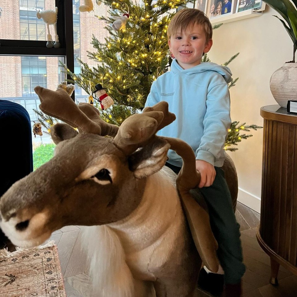 Oscar was all smiles as he posed for a snap on a reindeer