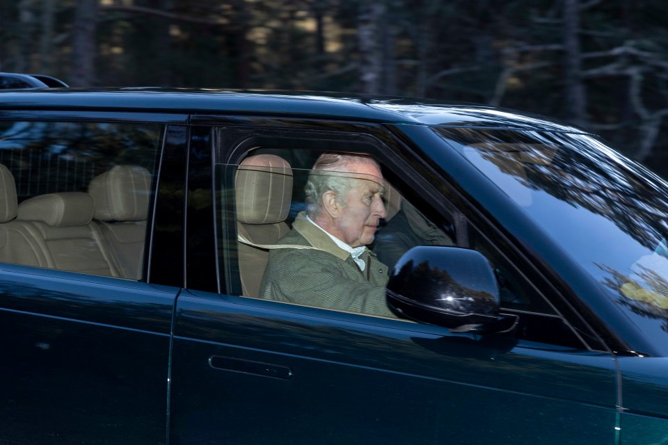 A stony-faced King Charles was pictured driving yesterday for the first time since Harry's book hit the shelves