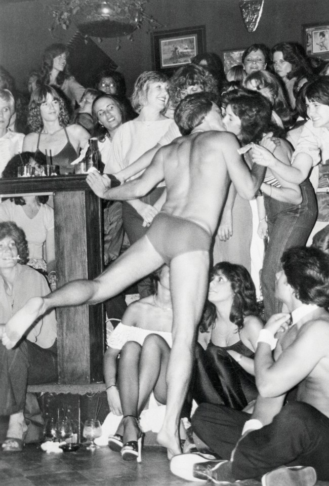 A male dancer is seen kissing a fan at Chippendales in LA, 1979