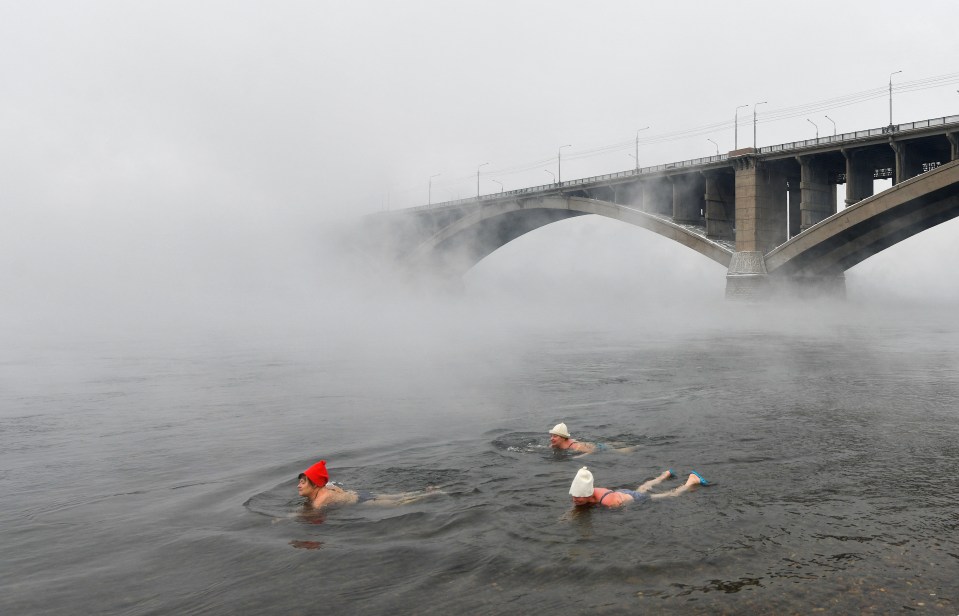 People jump into freezing lakes and rivers to mark Orthodox Epiphany