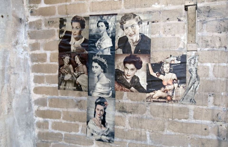 Pictures of the Queen and other famous faces on the wall