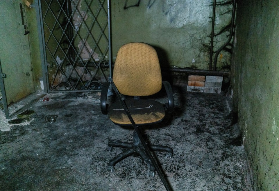 Plastic ties for torture and a broken chair are seen inside a basement of an office building