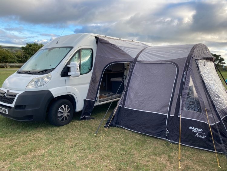 Julie bought an awning so the couple can cook outside of their van