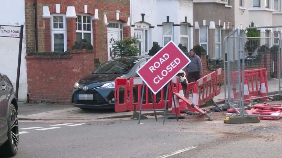 Cars avoiding the road closure in Southall, West London