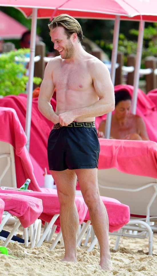 Olly Murs had a rummage down his swimming shorts while on holiday with fiancée Amelia Tank