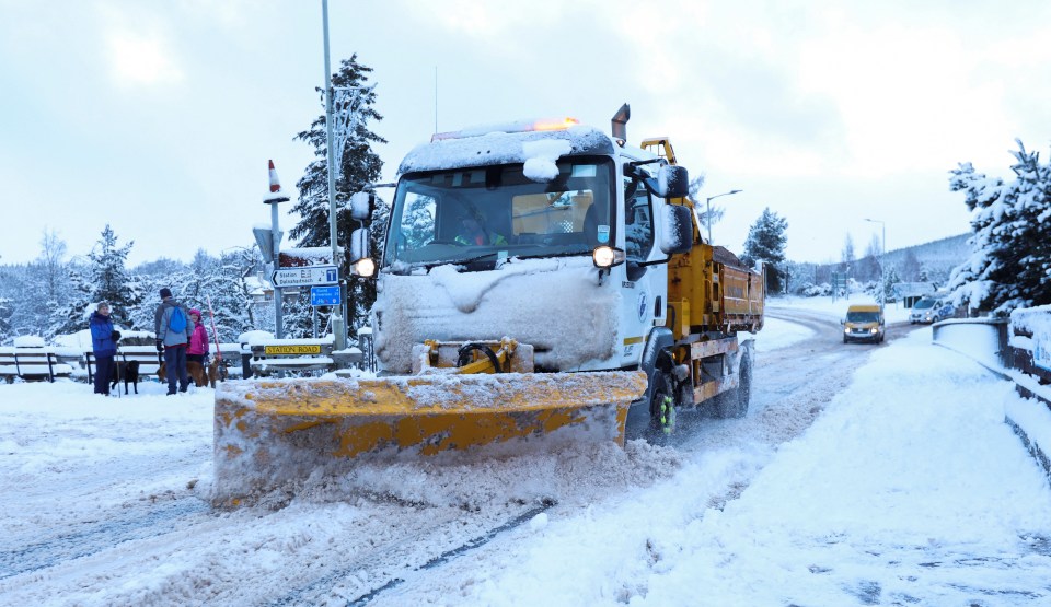 A snow plough clears a road in Carrbridge in the Scottish Highlands